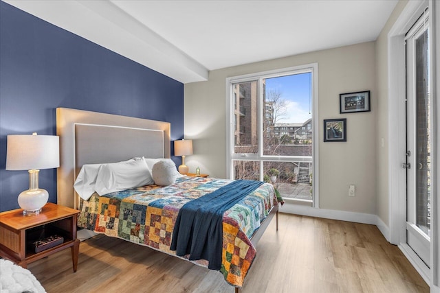 bedroom with wood finished floors and baseboards