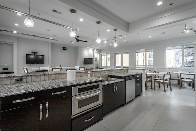 kitchen featuring open floor plan, appliances with stainless steel finishes, plenty of natural light, and visible vents