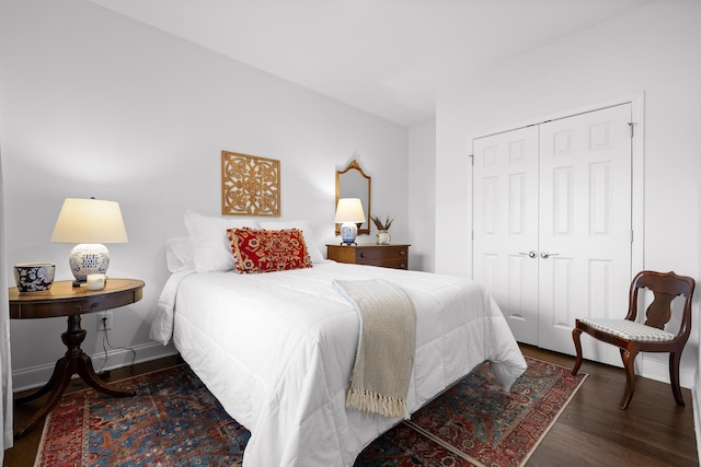 bedroom featuring a closet, wood finished floors, and baseboards