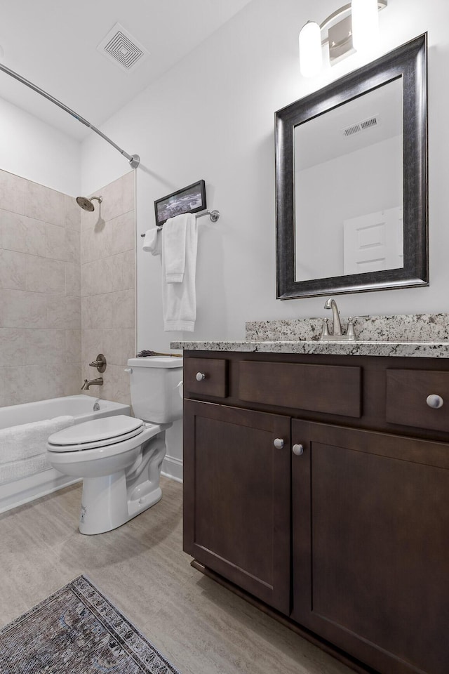 full bath featuring toilet, visible vents,  shower combination, and vanity