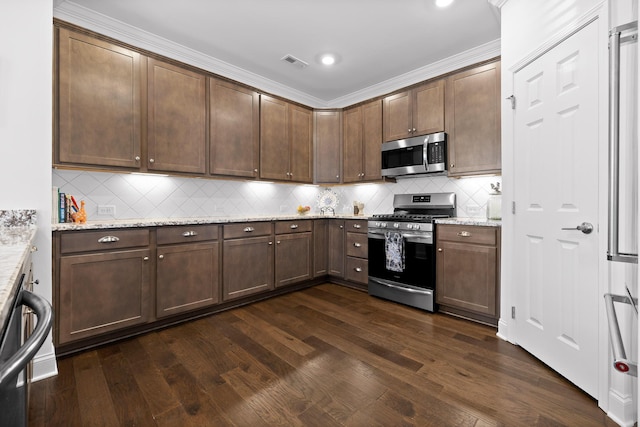 kitchen with dark wood-style floors, visible vents, appliances with stainless steel finishes, and light stone counters