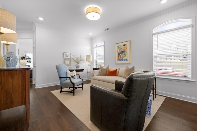 living area with baseboards, dark wood-style flooring, visible vents, and crown molding