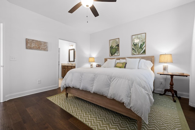 bedroom featuring ensuite bath, baseboards, and wood finished floors