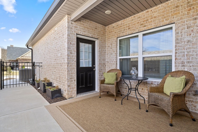 property entrance with brick siding and a gate