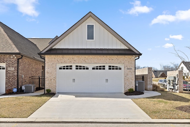 view of front of home with concrete driveway, brick siding, board and batten siding, and central air condition unit