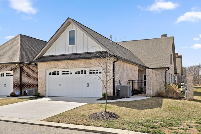 view of property exterior with brick siding, a chimney, concrete driveway, an attached garage, and central AC unit