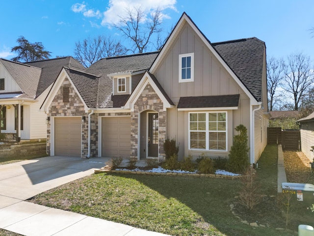 view of front facade with a garage, a shingled roof, concrete driveway, a front lawn, and board and batten siding