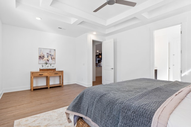 bedroom featuring visible vents, baseboards, a ceiling fan, coffered ceiling, and wood finished floors