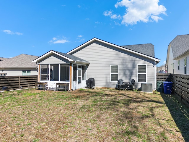 back of house with a sunroom, a fenced backyard, cooling unit, and a yard