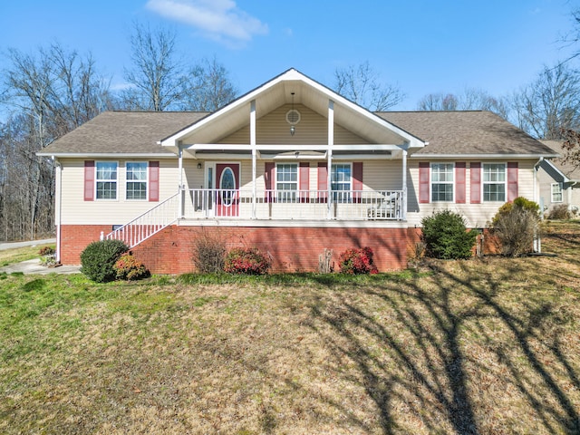 single story home with covered porch, stairway, a front lawn, and brick siding