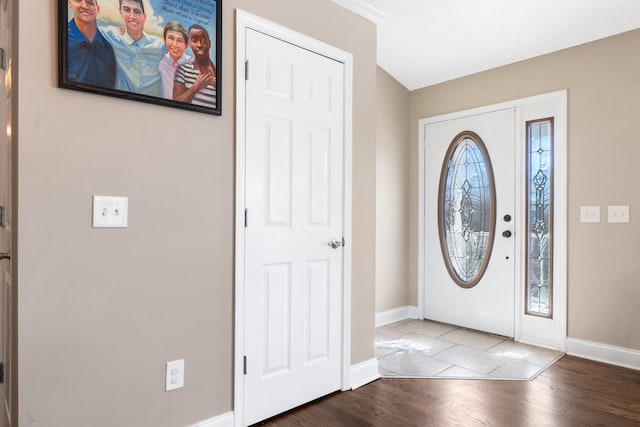 entryway with wood finished floors and baseboards