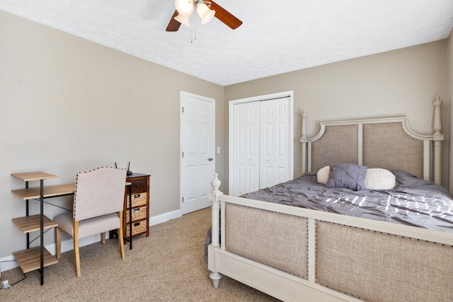 carpeted bedroom featuring a textured ceiling, a closet, and baseboards