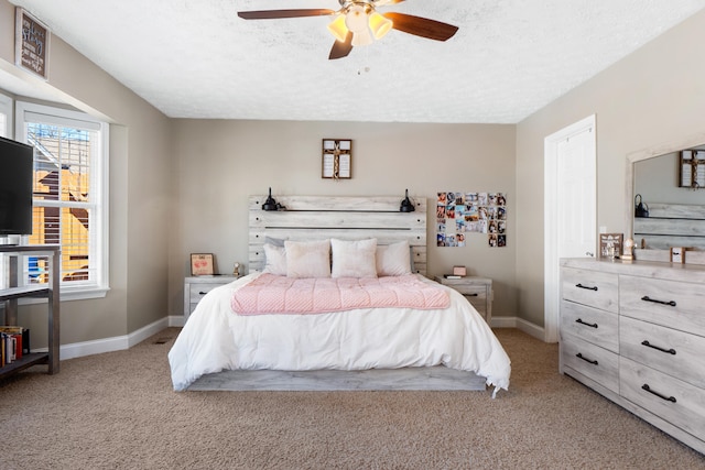 bedroom with light carpet, ceiling fan, baseboards, and a textured ceiling
