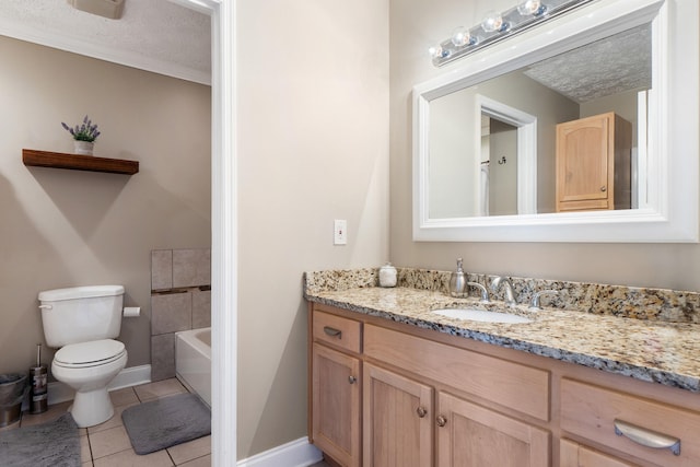 bathroom featuring a bathtub, toilet, vanity, tile patterned flooring, and baseboards
