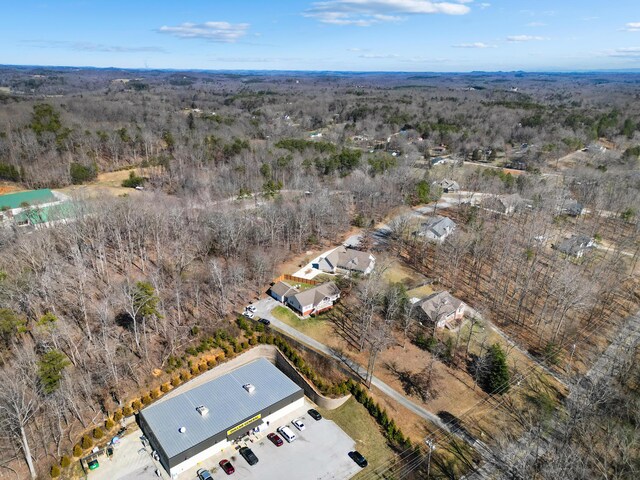 bird's eye view featuring a wooded view