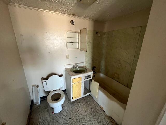 bathroom featuring toilet, shower / bathtub combination, a textured ceiling, and vanity