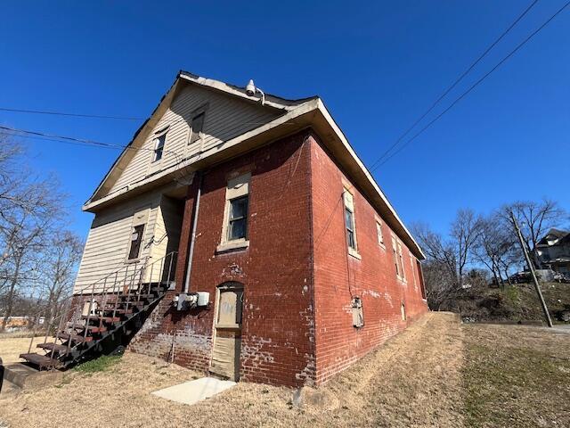 view of property exterior with brick siding