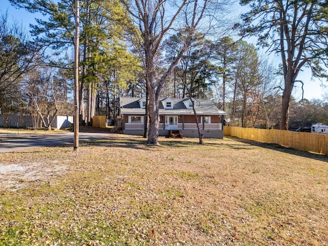 exterior space featuring crawl space, fence, and a front lawn