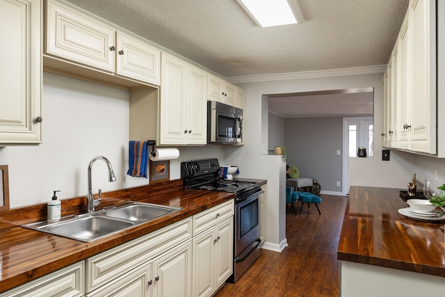 kitchen with electric range, stainless steel microwave, and wood counters