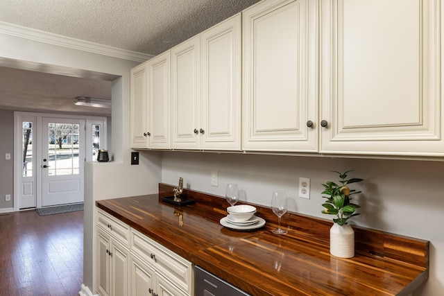 interior space featuring crown molding, dark wood-type flooring, and a textured ceiling