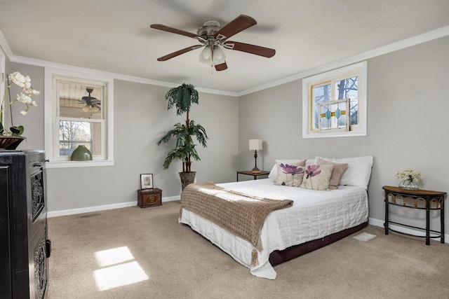 carpeted bedroom featuring baseboards, visible vents, and ornamental molding