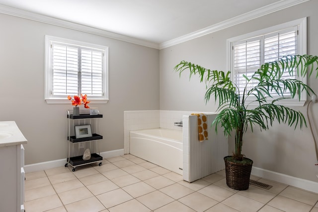 bathroom featuring baseboards, ornamental molding, tile patterned floors, vanity, and a bath