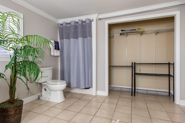 bathroom with toilet, a shower with curtain, ornamental molding, and tile patterned floors