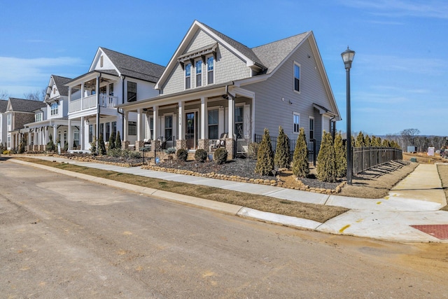 view of front of property with covered porch and fence