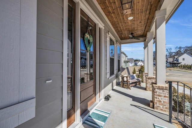 view of patio / terrace with a porch, a residential view, and a ceiling fan