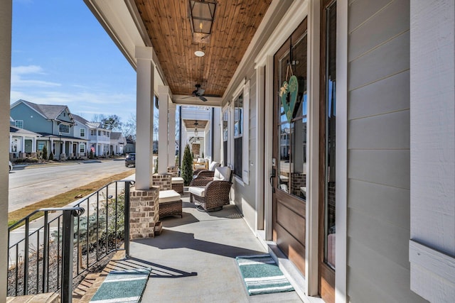 view of patio with covered porch, a residential view, and a ceiling fan