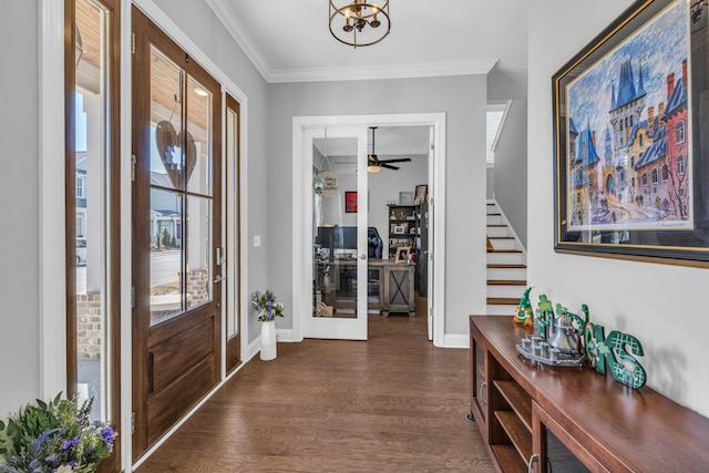 foyer with ornamental molding, dark wood-style flooring, baseboards, and stairs