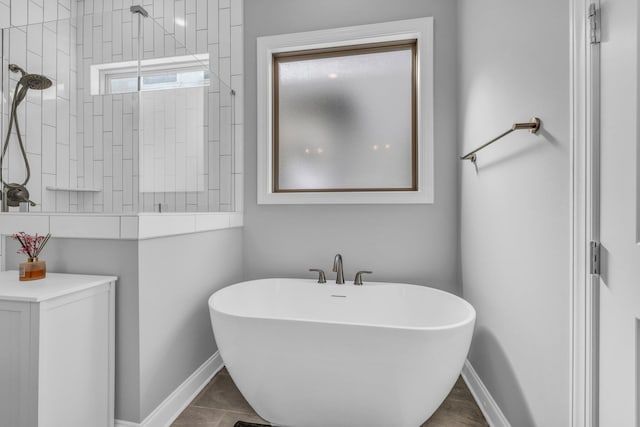 full bathroom featuring tiled shower, a soaking tub, and baseboards