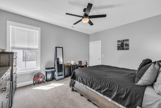 bedroom featuring ceiling fan, visible vents, and light colored carpet