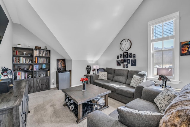 living room with light carpet, vaulted ceiling, and baseboards