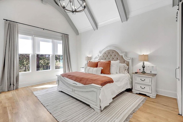 bedroom featuring lofted ceiling with beams, light wood finished floors, a notable chandelier, and baseboards