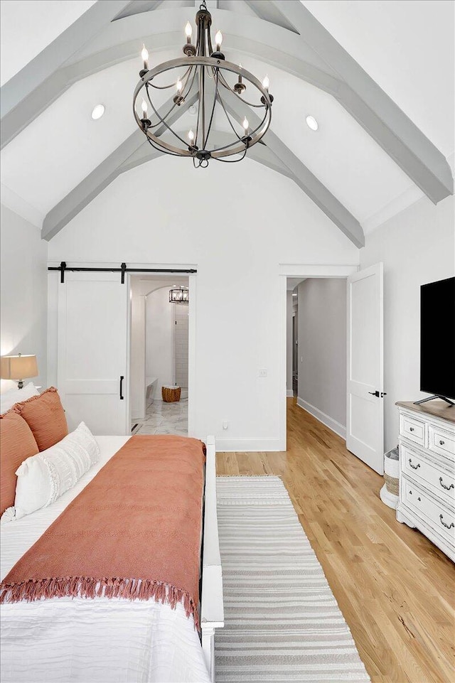 bedroom with a barn door, baseboards, light wood-style flooring, vaulted ceiling with beams, and recessed lighting