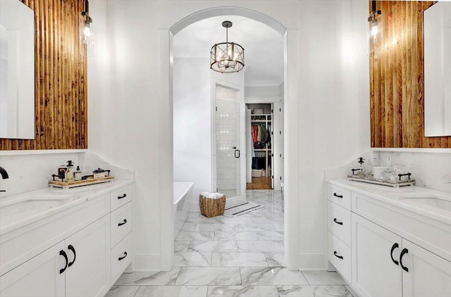 bathroom with a stall shower, marble finish floor, a sink, and a freestanding bath