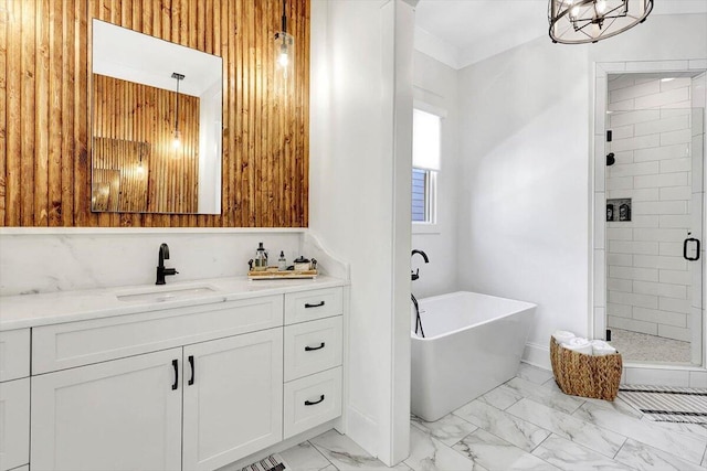 bathroom with marble finish floor, a freestanding bath, a shower stall, and vanity