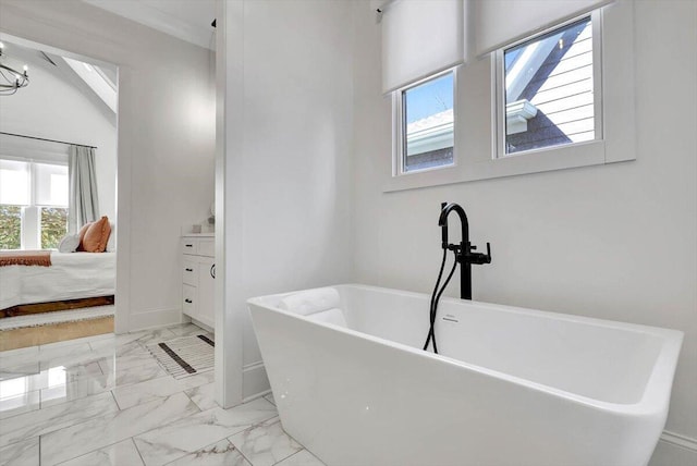 full bathroom featuring marble finish floor, a soaking tub, vanity, ensuite bath, and baseboards