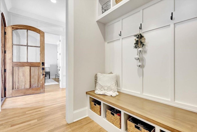 mudroom with light wood finished floors and baseboards