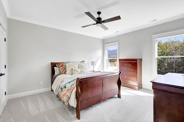 bedroom with light carpet, multiple windows, visible vents, and crown molding