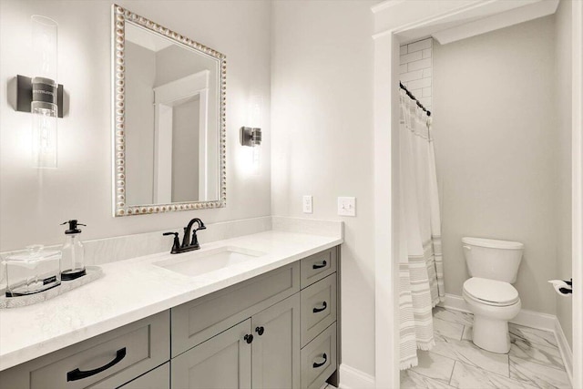 full bath with toilet, marble finish floor, vanity, and baseboards