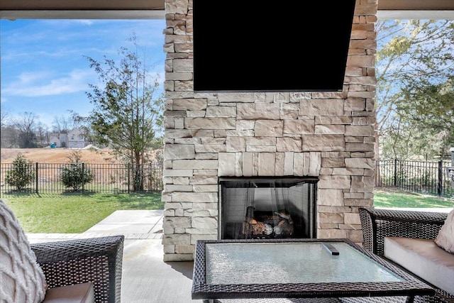 view of patio with an outdoor stone fireplace and fence