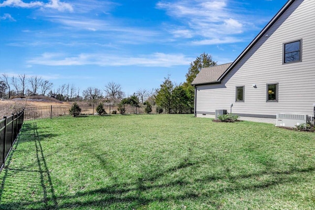 view of yard with a fenced backyard and central AC