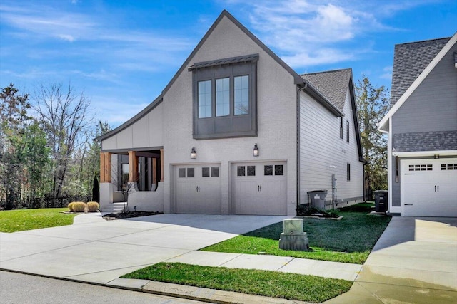 view of front of house featuring a garage, a front lawn, and concrete driveway