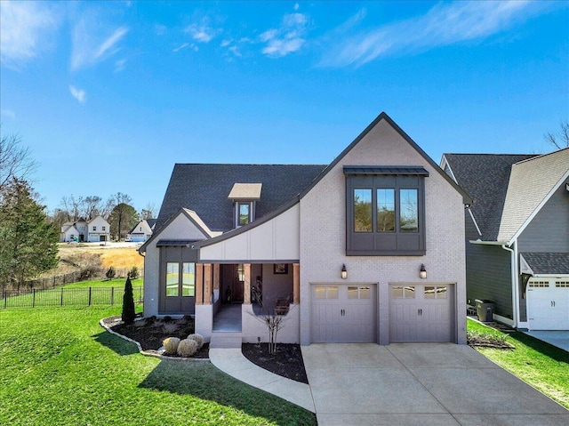 modern farmhouse style home with a front yard, concrete driveway, fence, and an attached garage