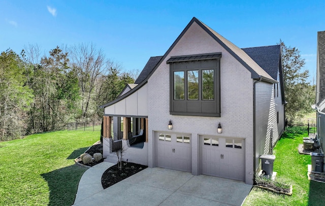 view of side of home with driveway, a shingled roof, a lawn, an attached garage, and brick siding