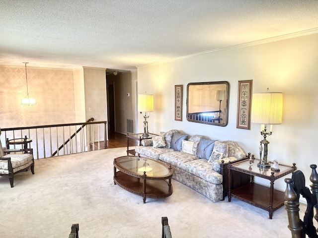 carpeted living area with a textured ceiling, ornamental molding, and visible vents