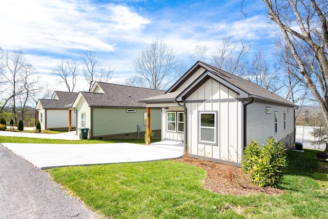 modern farmhouse style home with a front yard, driveway, a shingled roof, crawl space, and board and batten siding