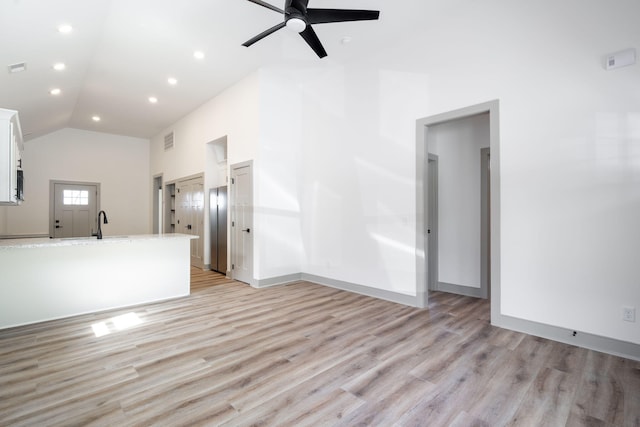 unfurnished living room with recessed lighting, light wood-type flooring, high vaulted ceiling, and a ceiling fan